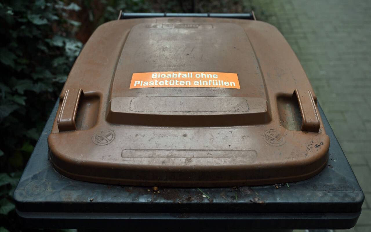 Eine Biotonne steht vor einem Wohnhaus. Vor allem in den größeren Städten Thüringens gehört die Biotonne schon länger zum Stadtbild. Doch es gibt auch Kommunen im Freistaat, die auf andere Entsorgungsmodelle setzen. Dem Landesamt für Umwelt, Bergbau und Naturschutz zufolge stieg die über die Biotonne entsorgte Abfallmenge in Thüringen auf rund 83.000 Tonnen im Jahr 2021 an.