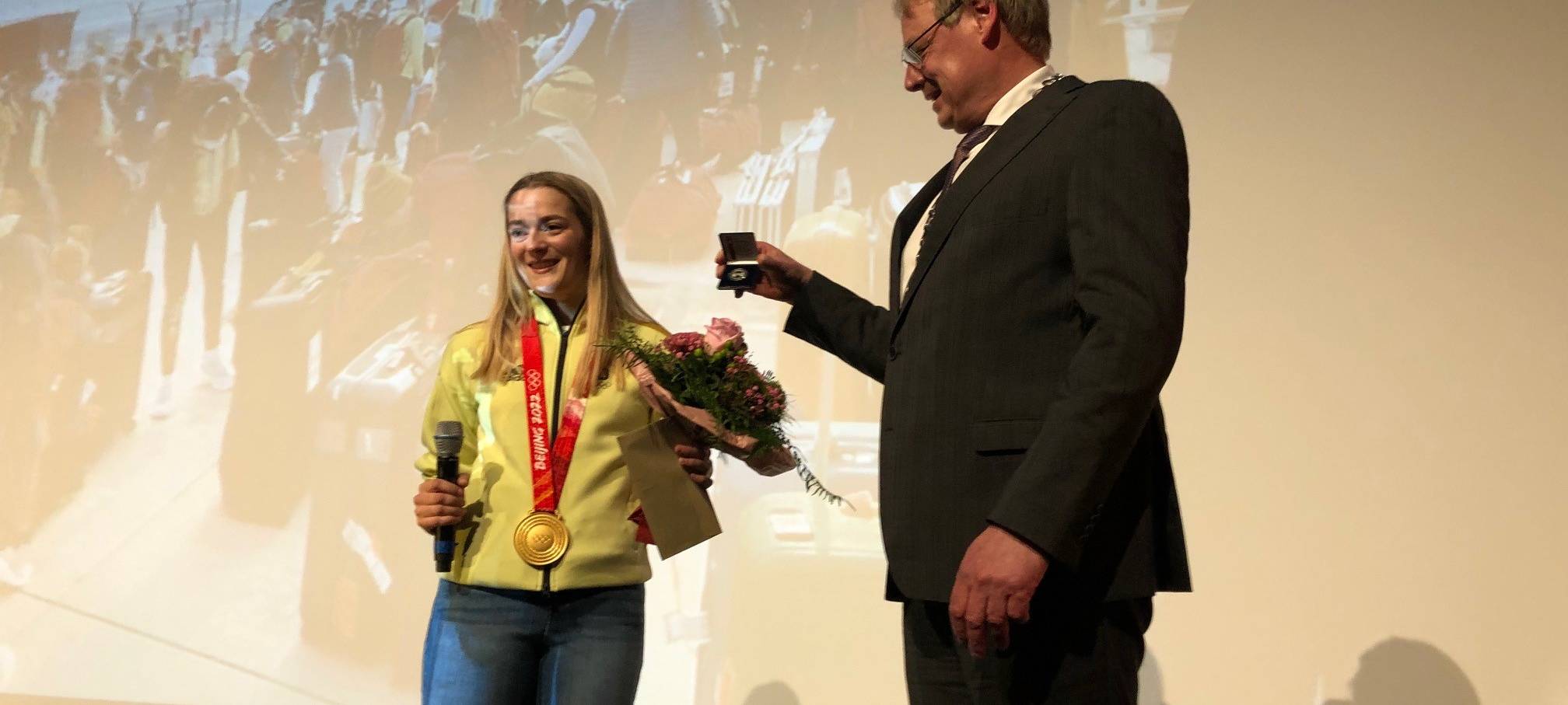 Auf einer Bühne in der Stadthalle Schmallenberg nahm Hannah Neise die Gratulationen entgegen.