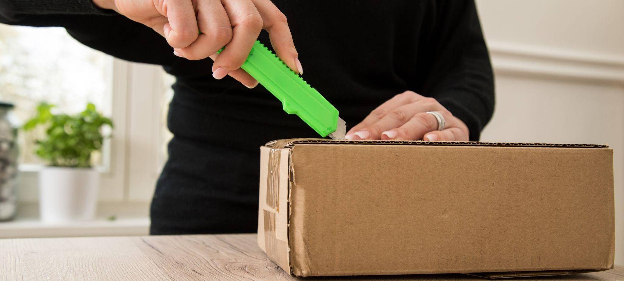 Frau öffnet ein Paket